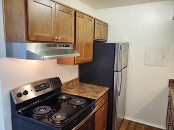 A kitchen with a stove and a refrigerator